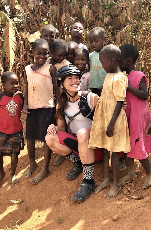 Nichole Baker with a crowd of children during her work in Uganda.