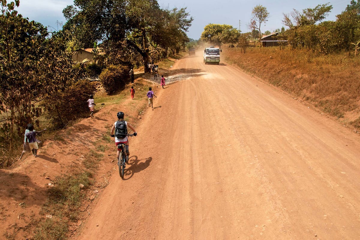 Nichole Baker with kids running beside her in Uganda