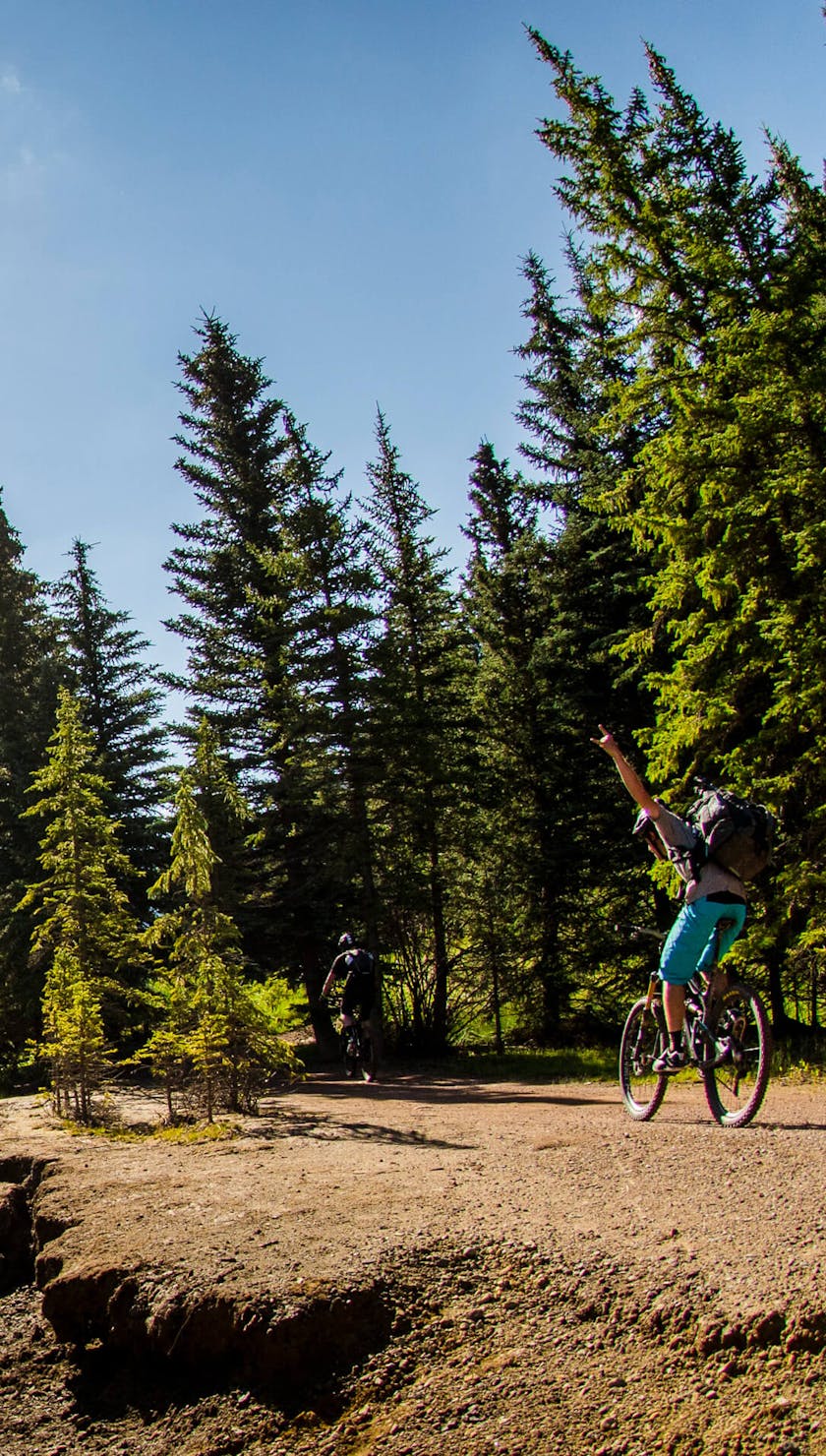 A stoked rider giving the horns on creekside single track