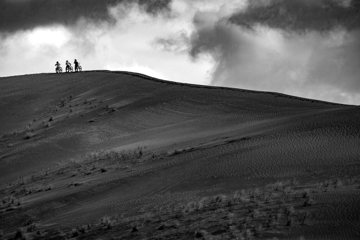 Riders hike a ridgeline