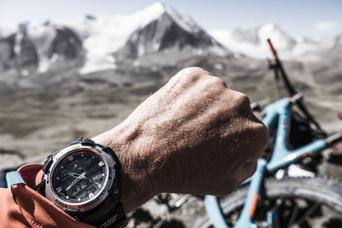 Dan Milner checking his watch, which indicates an elevation of 4310m